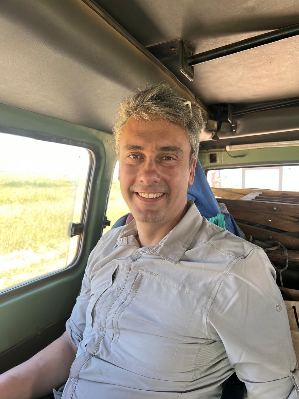 Lars Friedrich, founder of Origin of Wonder, on a safari vehicle